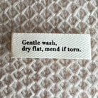 Gentle wash dry flat mend if torn Etiquette en tissu PetiteKnit - Petite Knit